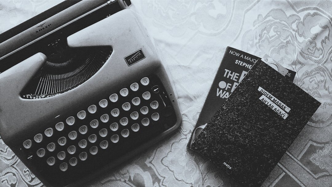 Books stacked next to an old typewriter