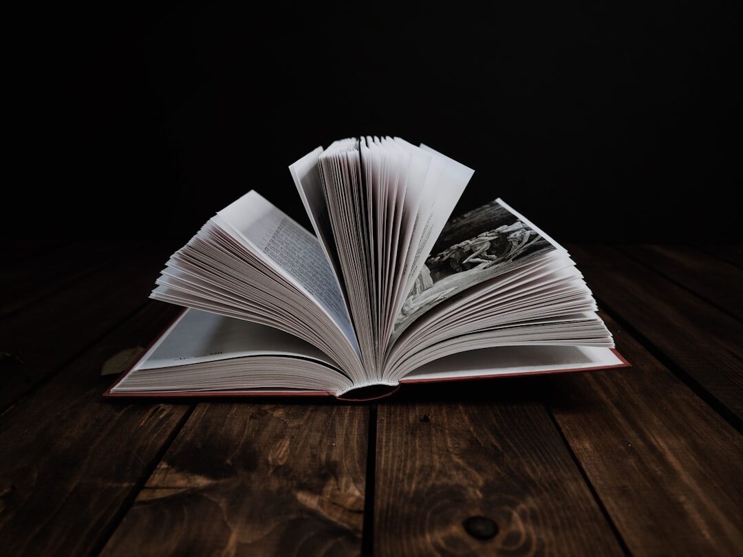 Single closed hardcover book on dark table
